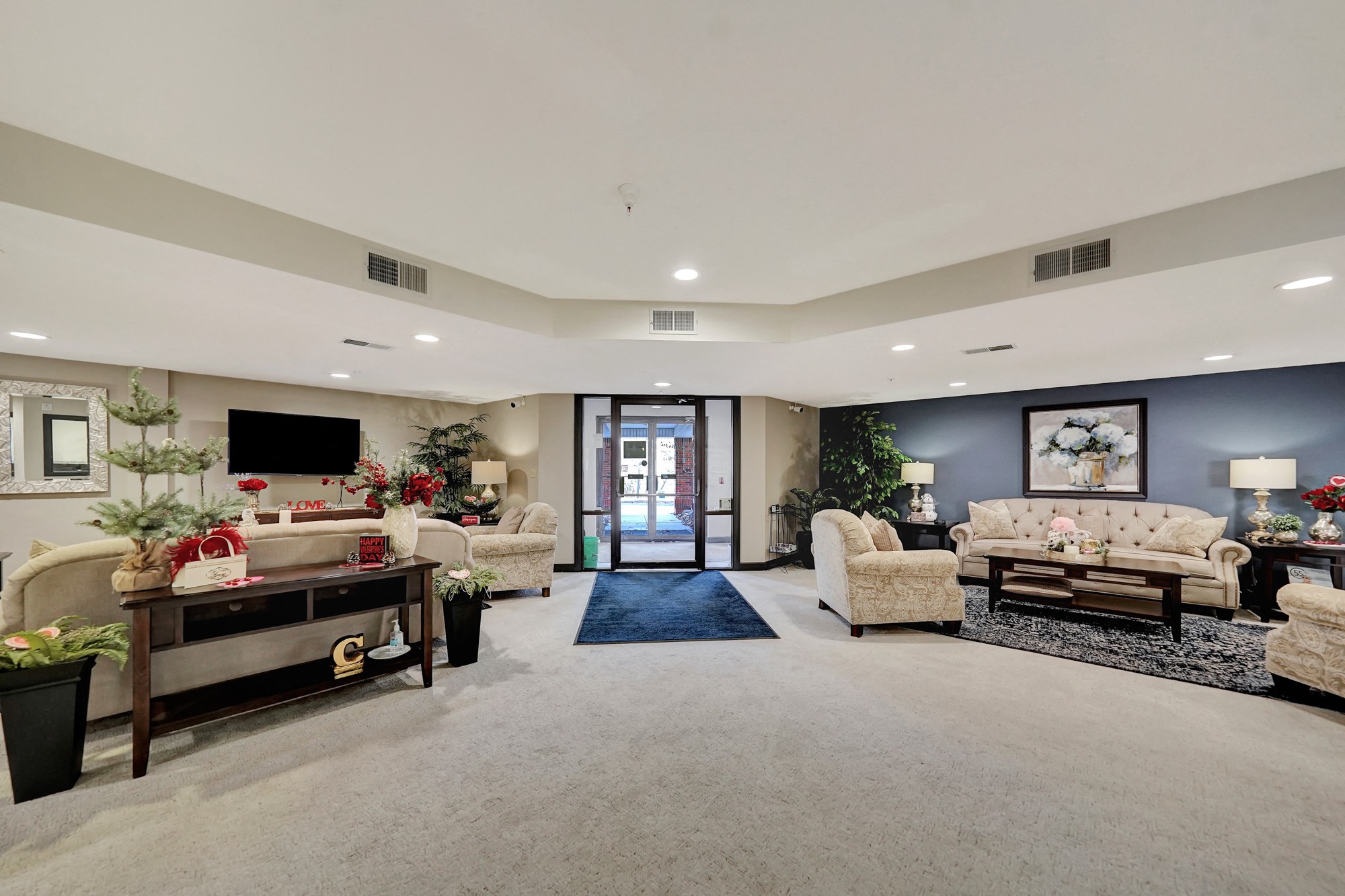 a large living room with couches and chairs and a tv